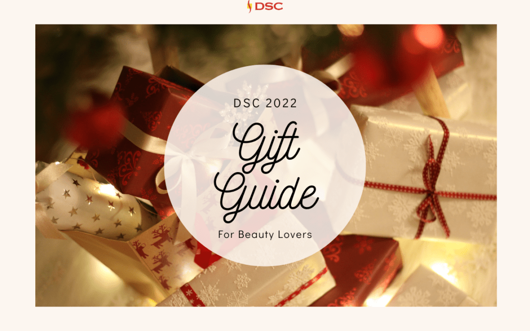 DSC 2022 Gift Guide for Beauty Lovers Text in circle over gifts and lights holiday image