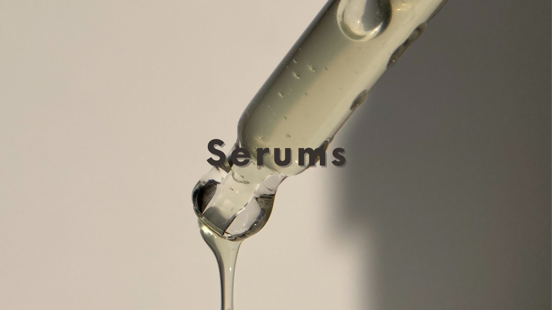 DSC Serums Blog Graphic with text Serums in black centered over image of serum dropper with serum dripping out