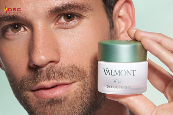 DSC Valmont Vitality Vital 24 Hour Light Product Graphic of bearded man holding Valmont Vital 24 Hour Light cream product in hand next to face