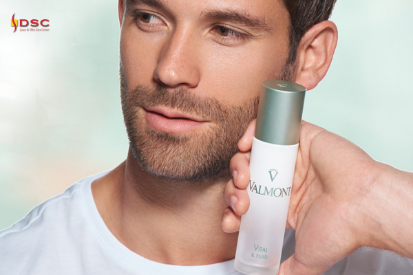 DSC Valmont Vitality Vital B. Fluid Product Graphic of bearded man holding Valmont Vital B. Fluid product in hand next to face