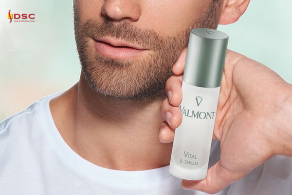 DSC Valmont Vitality Vital B. Serum Product Graphic with bearded man holding Valmont Vital B. Serum product in hand next to bottom half of face