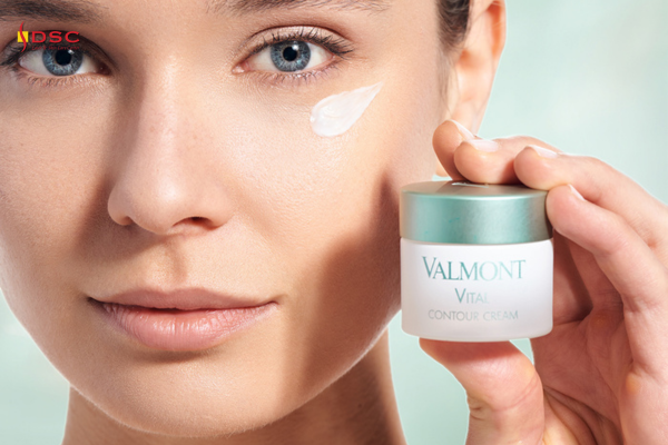 DSC valmont vitality vital contour cream graphic with woman holding Valmont Vital Contour Cream eye cream product next to face with smear of product right under left eye