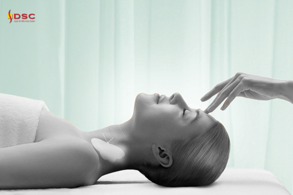 DSC Valmont Vitality Facial Graphic with woman on treatment table with hand touching her forehead and green background