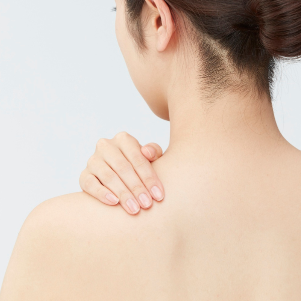 woman facing away with hand on shoulder